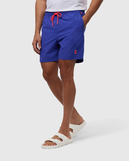 Bottom view of a person wearing Men's Lancaster Hydrochromic Swim Trunk, showcasing the innovative hydrochromic technology revealing a hidden Bunny logo pattern when wet, with contrasting trims and a silicone Bunny patch