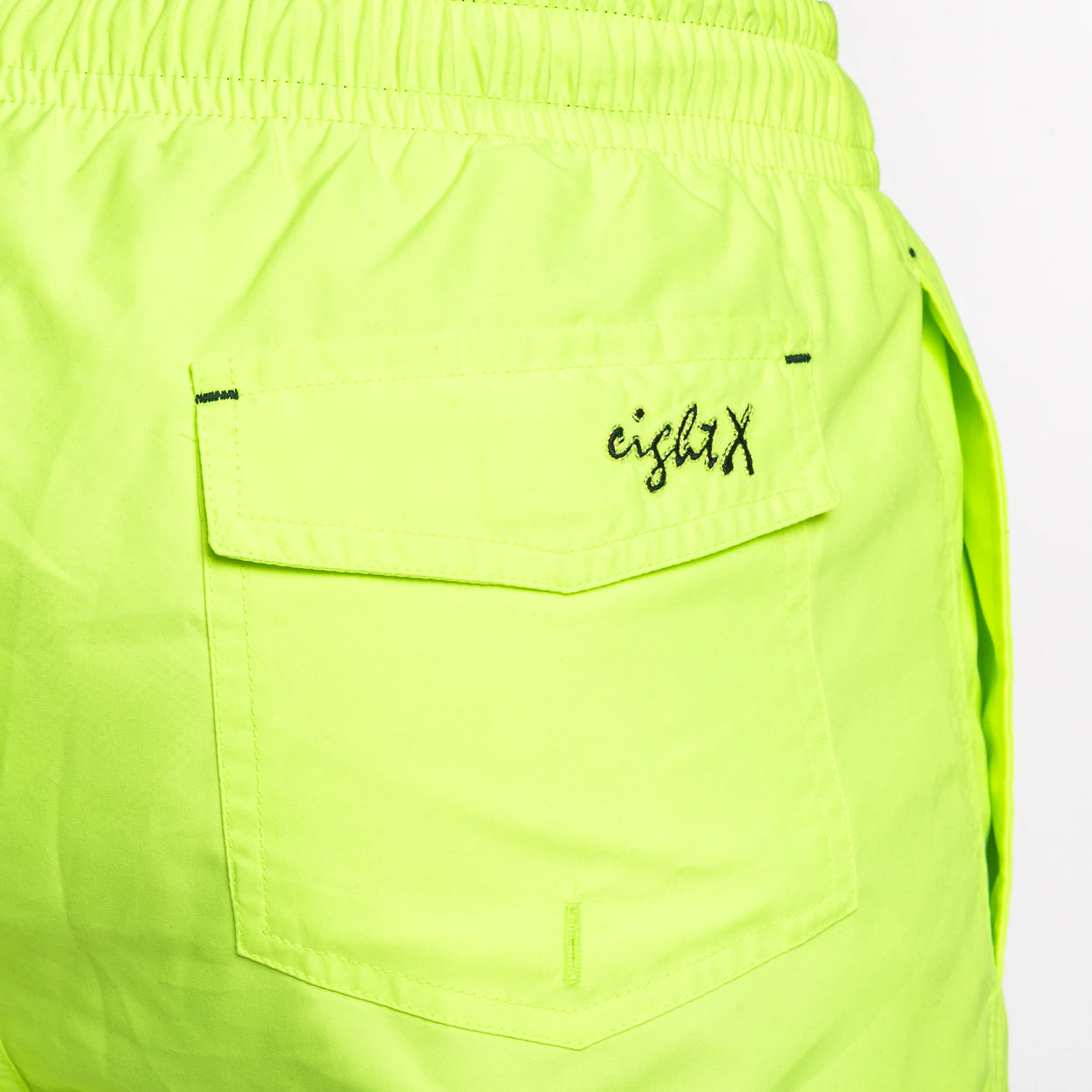 Close-up view of the backside pocket on FROG Swim Trunks in Neon Yellow, highlighting the convenient storage space for gadgets, crafted from premium polyester with mesh inner lining for added comfort