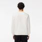 Back view of a person wearing Lacoste Men's Flocked Fleece Sweatshirt in white, emphasizing the classic fit and natural ease, perfect for everyday wear