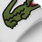 Close-up view of the oversized embroidered green crocodile branding on the Lacoste Men's Croco 319 4 US CMA Slide Sandal, emphasizing the detailed craftsmanship