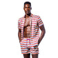 Casual shot of a man wearing the Sunset Alchemy Swim Trunks with a shirt but not buttoned, highlighting their stylish and versatile design suitable for various summer occasions