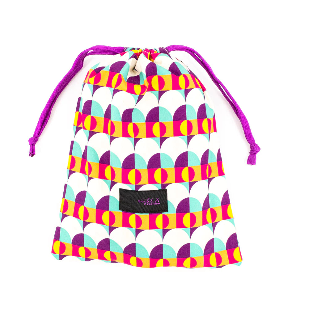Sunset Alchemy Swim Trunks wrapped up in a cloth bag, showcasing the matching drawstring bag included for convenient storage and transport, perfect for summer adventures